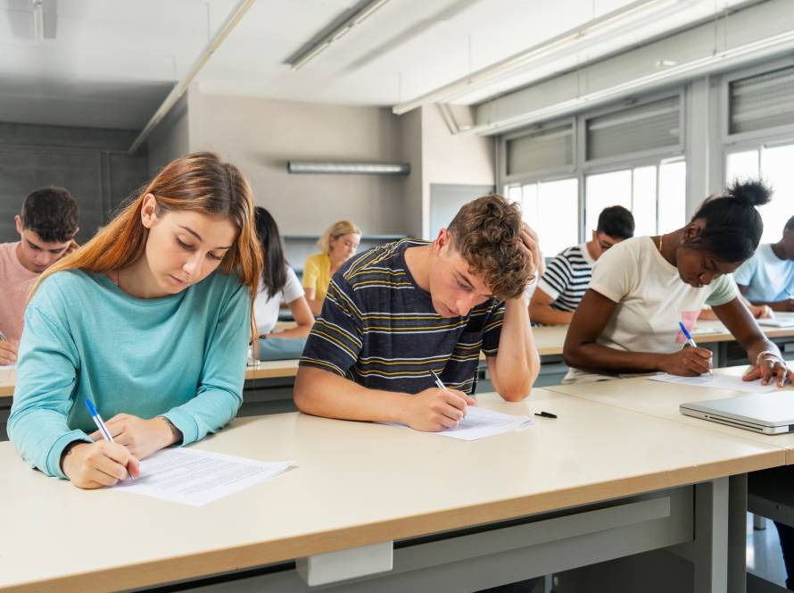 Multi ethnic teenager students taking exam at High School